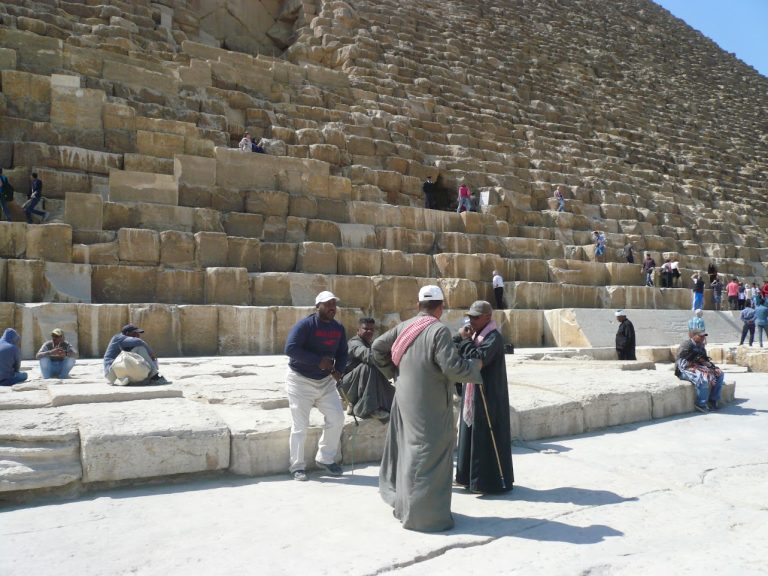 sun is shining at Giza but everyone wrapped in warm clothes from cold wind.