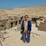 Mara, storyteller and guide, standing atop the entrance to the Osirion in Abydos, Egypt