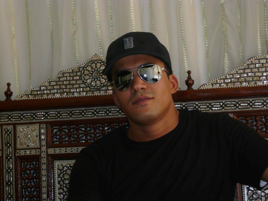 Amr the manager and chef at Mara House Luxor sitting on traditonal mother of pearl decorated chair