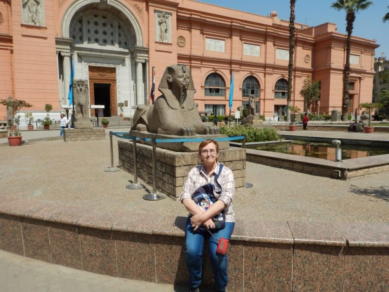 Mara sitting on a low wall outside the Egyptian Museum in Tahrir Square, Cairo