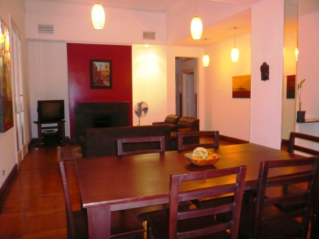 large comfortable sitting room with fireplace, TV and couches