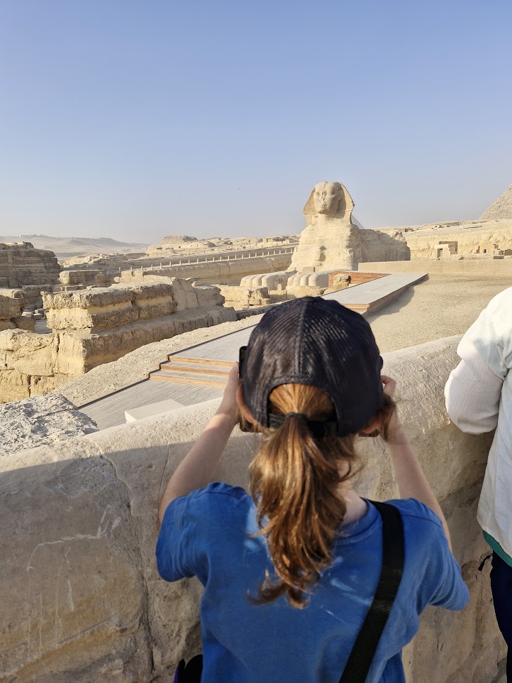 Back view of young boy taking a photo of the Sphinx
