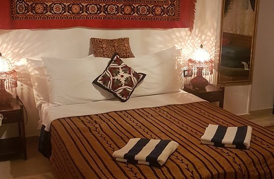 Our Double bedroom at Mara House double beed, bedside tables, wallhanging behind the bed